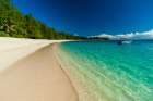A boat anchored off the shore of a pristine tropical beach Denis Island-Seychelles Art Print